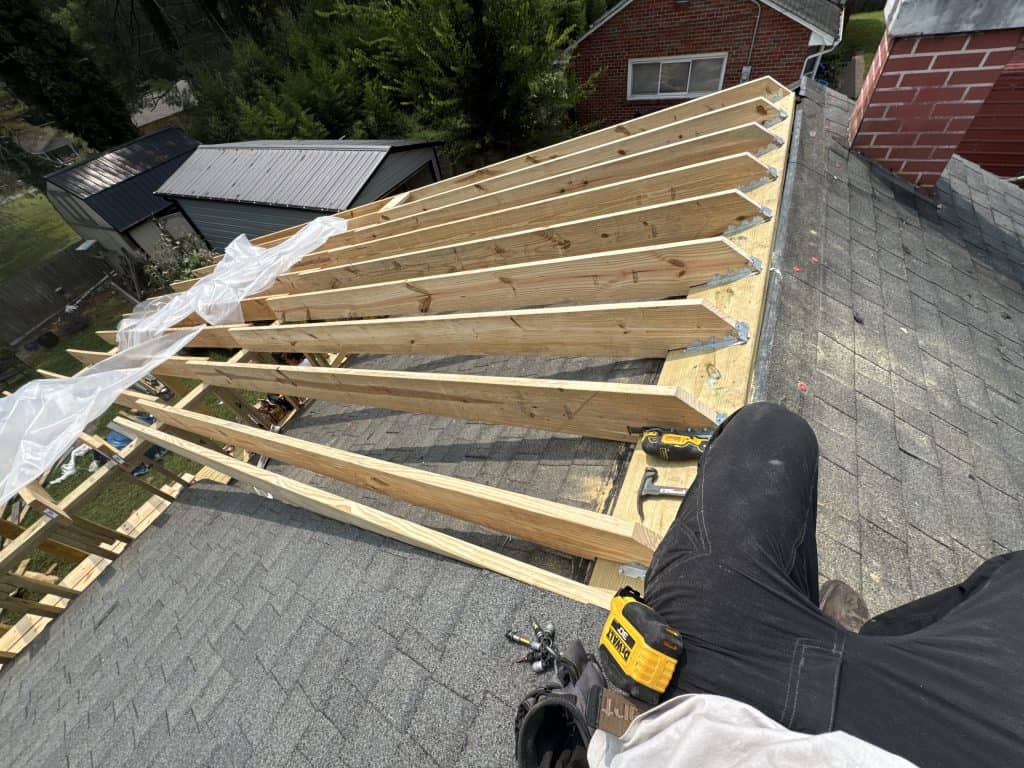 Roofing and roof extension project in Knoxville TN showing new roof framing, decking, and architectural shingle installation in progress
